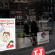 People are reflected in a window of a hair salon shuttered due to the outbreak of coronavirus disease (COVID-19), in Hoboken, New Jersey